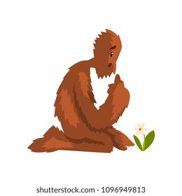 Funny bigfoot sitting on its knees and looking at flower, mythical creature cartoon character vector Illustration on a white background