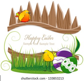 Funny birds with Easter eggs on the background of the wooden fence
