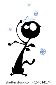 Funny black cat surprised by snowflakes falling.