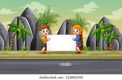 Funny a boy and girl holding blank sign on the roadside