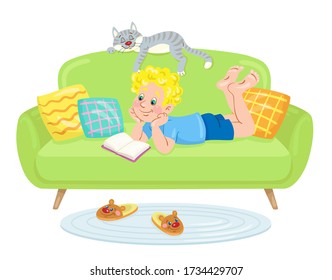 Funny boy is reading while lying on a green sofa. A sleeping cat is nearby. In cartoon style. Isolated on white background. Vector flat illustration.