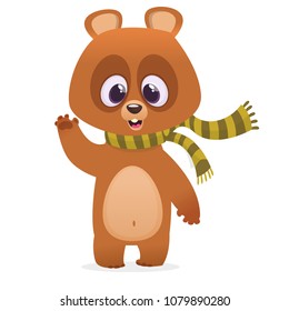  Funny cartoon brown bear in a skarf smiling and waving hand. Vector illustration of a bear mascot character