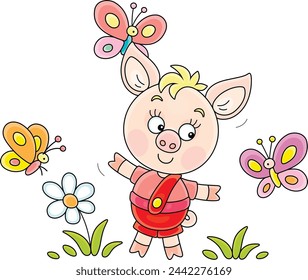 Funny cartoony little piglet merrily playing with colorful butterflies on a green summer lawn, vector cartoon illustration on a white background