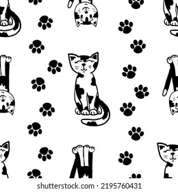 A funny cat pattern in black and white, two funny cats with paw prints around seamless background