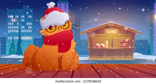 Funny cat in santa hat and scarf at christmas eve. Cute pet sit on wooden desk under falling snow at night street with cafe stall at winter season. Cartoon kitten xmas character, Vector illustration