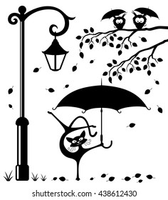 Funny cat with an umbrella in the park under a streetlight and owls on a branch.