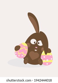 Funny chocolate Easter bunny with colorful holiday eggs