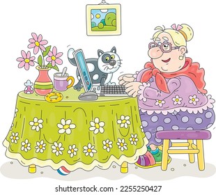 Funny chubby granny and her merry cat sitting at their beautiful kitchen table with a laptop, browsing pages on Internet and chatting with friends in social networks and messengers