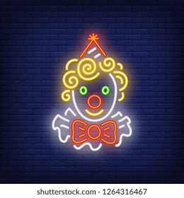 Funny clown head neon sign. Circus performance advertisement design. Night bright neon sign, colorful billboard, light banner. Vector illustration in neon style.