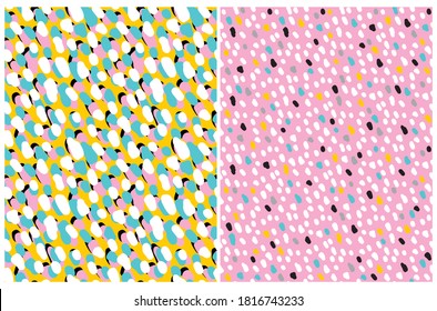 Funny Colorful Geometric Seamless Vector Patterns. White, Black, Gray and Blue Hand Drawn Spots on a Pink and Yellow Background. Lovely Infantile Irregular Doodle Print.