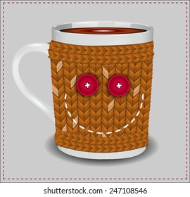 Funny cup in a sweater with buttons and thread embroidered smile.