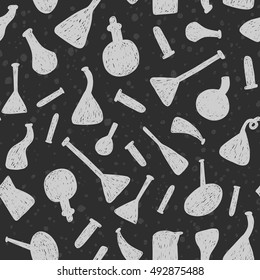 Funny doodle vector seamless pattern with black chemistry glass flasks silhouettes on a white background