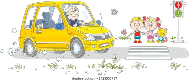 Funny elderly driver in his small yellow car and a little children with a funny cat waiting for green traffic light at a pedestrian crossing of a town street near a park on a sunny summer day