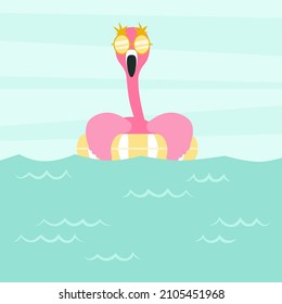 Funny flamingo with a swimming circle in the water.