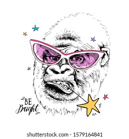 Funny Gorilla in a pink glasses and with a star. Be bright - lettering quote. Humor card, t-shirt composition, hand drawn style print. Vector illustration.