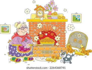 Funny granny with a merry cat baking a tasty sweet traditional cake in an old bricky oven for a festive table in her pretty kitchen decorated with pictures, flowers in a vase and a toy clock