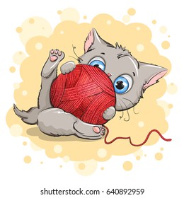 Funny gray kitten playing with a ball of yarn. Background yellow