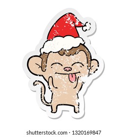 funny hand drawn distressed sticker cartoon of a monkey wearing santa hat