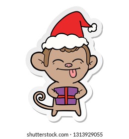 funny hand drawn sticker cartoon of a monkey with christmas present wearing santa hat