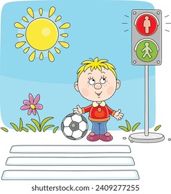 Funny little boy with his football waiting for green traffic light at a pedestrian crossing of a town street on a sunny summer day, vector cartoon illustration