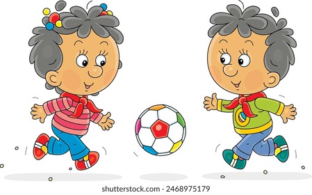 Funny little girl and boy merrily running and playing with a colorful ball on a playground in a park