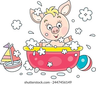 Funny little piglet playing in a bubble bath and splashing with foam in a home bathroom with toys, vector cartoon illustration isolated on a white background