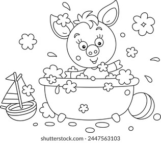 Funny little piglet playing in a bubble bath and splashing with foam in a home bathroom with toys, black and white vector cartoon illustration for a coloring book