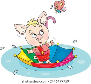 Funny little pink piglet floating in its colorful toy umbrella through a large puddle after warm summer rain, vector cartoon illustration on a white background