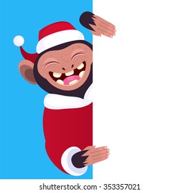 Funny monkey holding a blank banner. Cartoon monkey in a Christmas hat peeking from behind a blank banner.