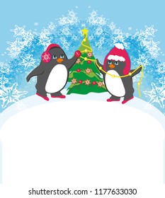 funny penguins decorating christmas tree