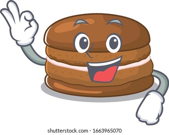 A funny picture of chocolate macaron making an Okay gesture