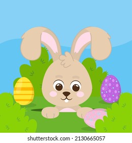 funny rabbit and easter eggs in grass