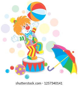 Funny red circus clown playing a big colorful ball and an umbrella, vector illustration in a cartoon style