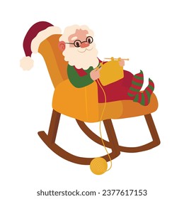 El gracioso Papá Noel tejiendo ropa en una mecedora en una cama blanca
