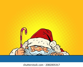 Funny Santa Claus is watching. Christmas and New Year. Winter seasonal holiday