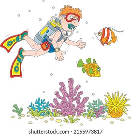 Funny scuba diver with a mask, flippers and an aqualung swimming with exotic fishes on a coral reef of a tropical sea on summer vacation, vector cartoon illustration isolated on a white background