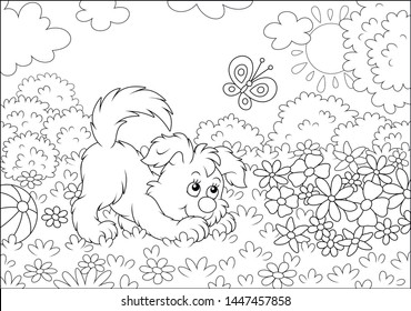 Funny small playful puppy playing with a butterfly among colorful flowers on green grass of a garden on a sunny summer day, black and white outline vector illustration in a cartoon style