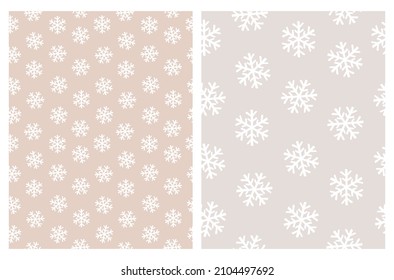 Funny Vector Patterns with Irregular Hand Drawn Simple Snowflakes Isolated on a Light Beige and Pastel Pink Background. Winter Holidays Print ideal for Wrapping Paper.White Abstract Winter Sky.