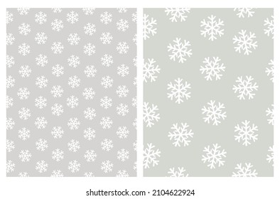 Funny Vector Patterns with Irregular Hand Drawn Simple Snowflakes Isolated on a Light Gray and Pale Green Background. Winter Holidays Print ideal for Wrapping Paper.White Abstract Winter Sky.