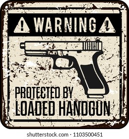 funny warning sign. protected by handgun.