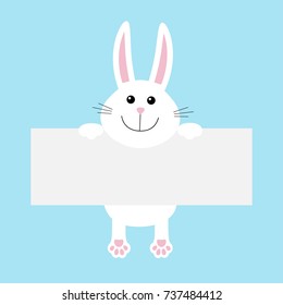 Funny white rabbit hare hanging on paper board template. Kawaii animal body with pawprint. Cute cartoon character. Baby card. Flat design style. Blue background Isolated. Vector illustration