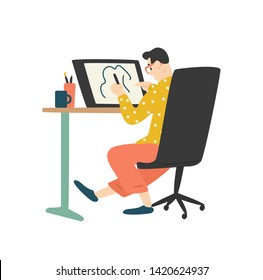 Funny young man sitting at desk and drawing on graphic tablet. Digital designer, illustrator or freelancer working at home. Cute guy enjoying his hobby. Flat cartoon colorful vector illustration.