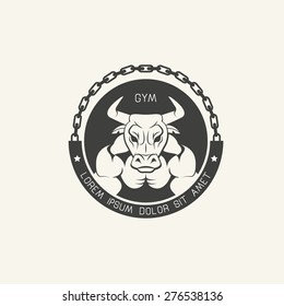 Furious muscled bull  in chains. Old school  round emblem for gym.