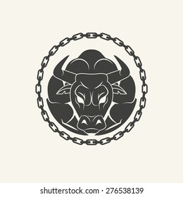 Furious muscled bull  in chains. Old school  round emblem.