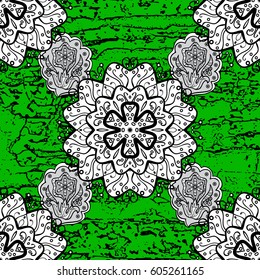 Furniture in classic style. Element woodcarving. Luxury furniture. Carving. Patina. Small depth of field. Pattern on green background with white elements. Green tree with rough trim.