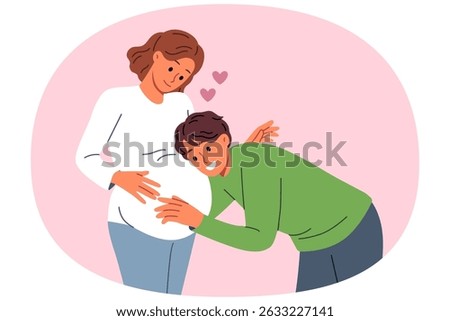 Future dad leans against belly of pregnant woman, listening to movements of baby in womb. Pregnant girl feels love and affection of groom, who is looking forward to birth of child.