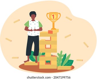 Future goals concept with happy dark skinned guy standing near tower with gold cup on top. Young man successful player winner with award. Family table game, entertainment for adults and kids