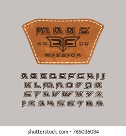 Futuristic font in the style of handmade graphics. Leather patch with space emblem. Print on grey background