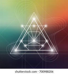 Futuristic vector art with interlocking hipster style triangles and other geometry shapes in front of blurry backdrop.
