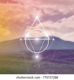 Futuristic vector art with interlocking hipster style triangles and other geometry shapes in front of blurry photo backdrop.